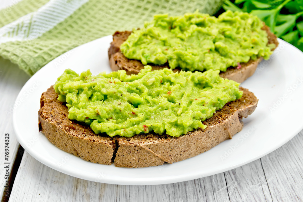Sandwich with guacamole on light board Sandwich with guacamole on light board
