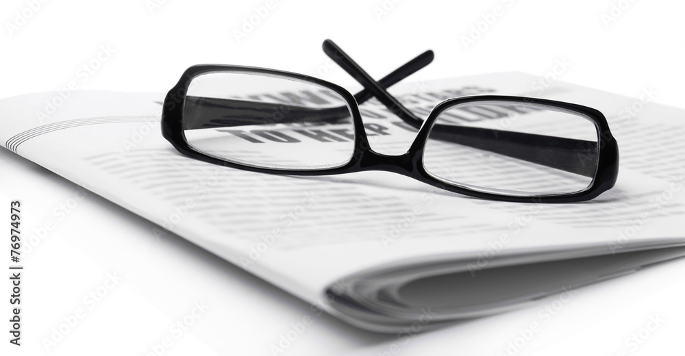Glasses and newspapers, close-up Glasses and newspapers, close-up