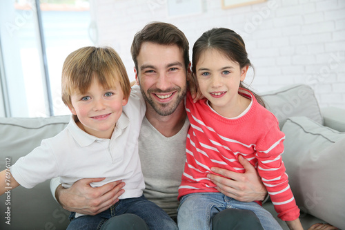 Portrait of cheerful daddy with kids photo