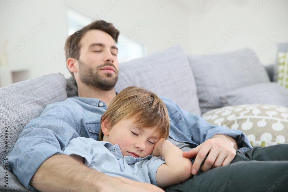 Father and son taking a nap on sofa Father and son taking a nap on sofa