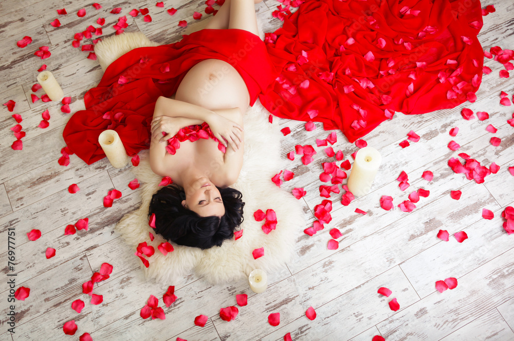 Portrait of a beautiful pregnant woman in red chiffon shawl