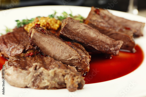 Steak on plate on table close up