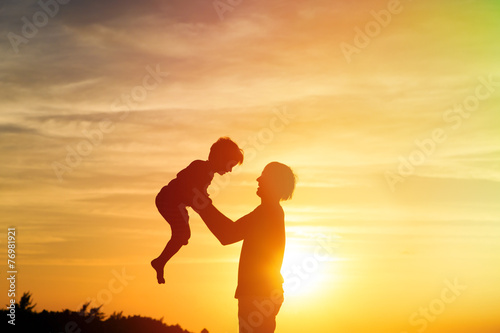 father and son play at sunset