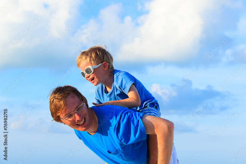 Father and little son playing on summer sky Father and little son playing on summer sky