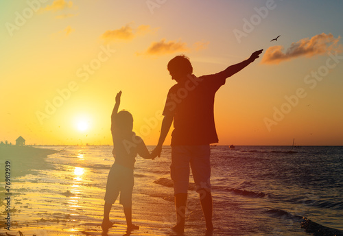 father and son having fun on sunset