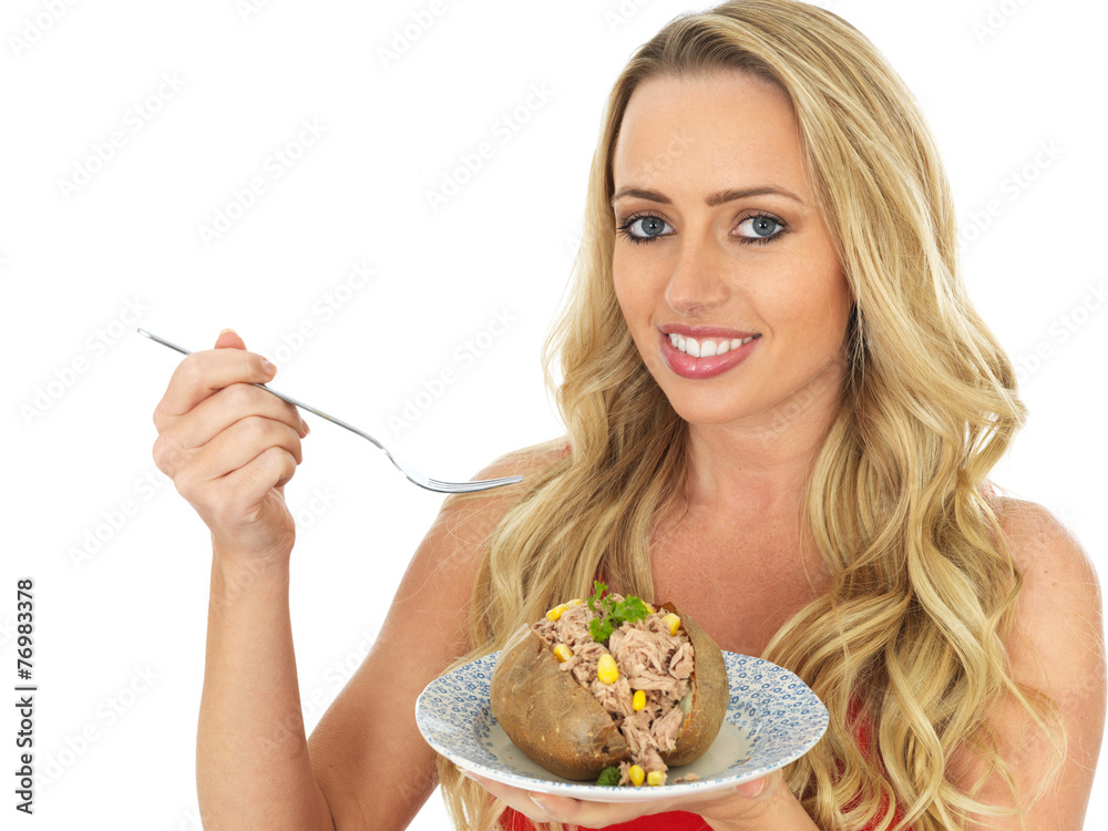 Young Woman Eating a Baked Potato with Tuna and Sweetcorn Young Woman Eating a Baked Potato with Tuna and Sweetcorn