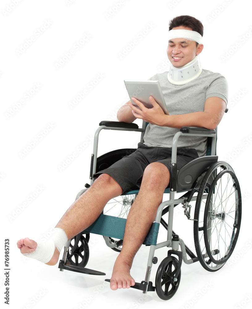 injured young man in wheelchair play gadget injured young man in wheelchair play gadget