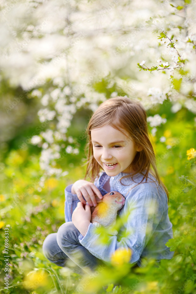 Adorable little girl in blooming cherry garden Adorable little girl in blooming cherry garden