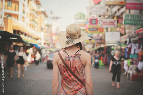 Young woman walking in Khao San, Bangkok photo