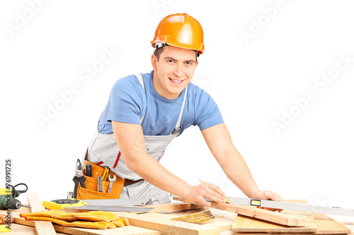 Carpenter working with wooden planks