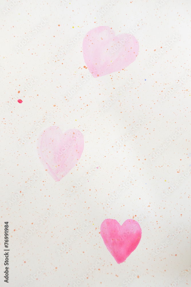two painted pink hearts on a paper