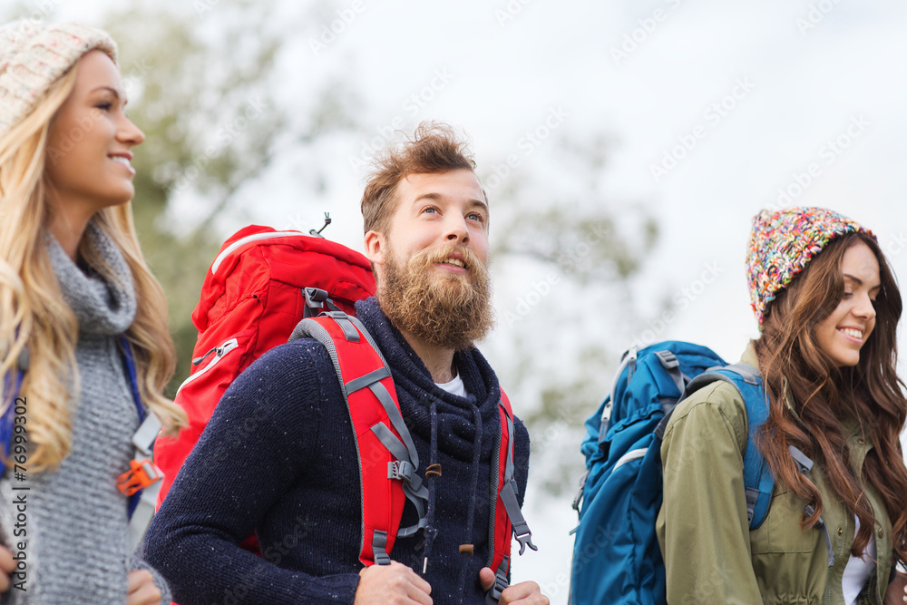 group of smiling friends with backpacks hiking group of smiling friends with backpacks hiking