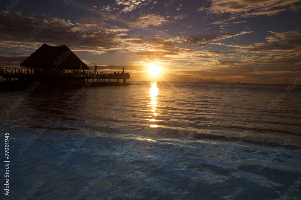 Maldives sunset over a bungalow.