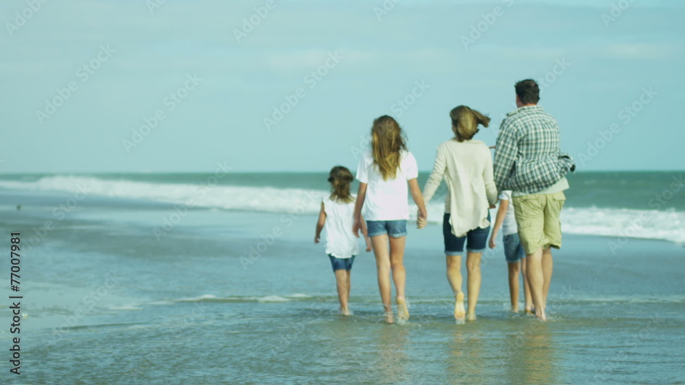 Caucasian Parents Three Young Daughters Walking Together Beach