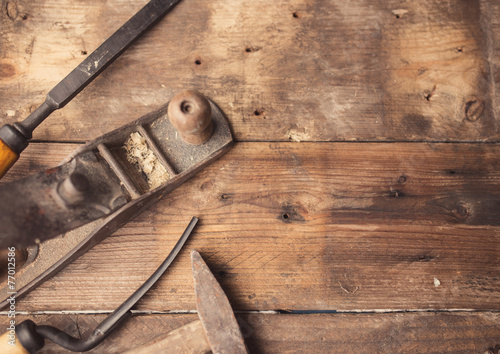 Od vintage hand tools on wooden background. Carpenter workplace.