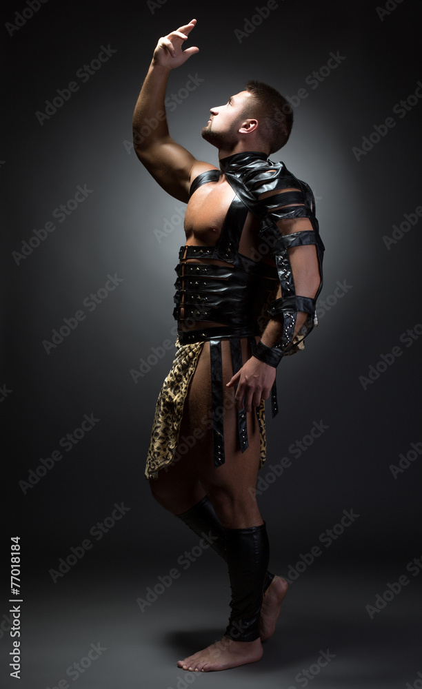 Fototapeta premium Image of handsome dancer posing as primitive man