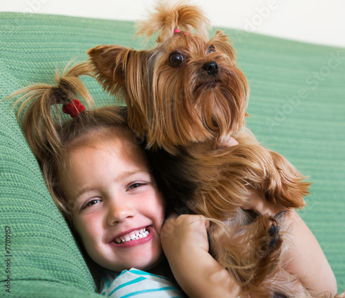 Female child playing with Yorkie