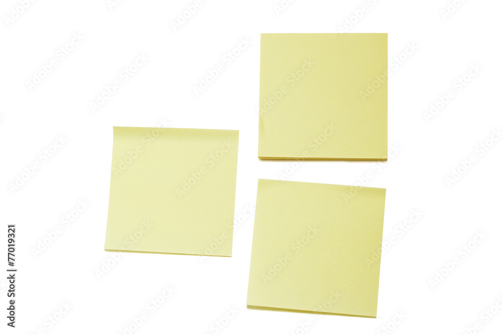 Two blank yellow Post-it notes and a stack, isolated
