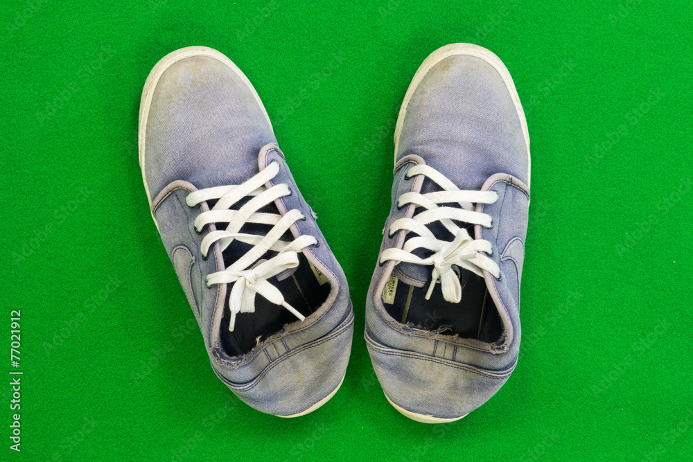 Canvas sneakers Placed on a green background Canvas sneakers Placed on a green background