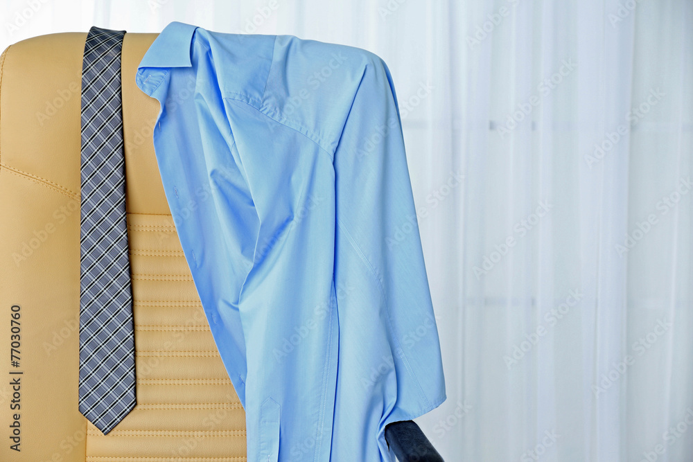 Men's clothes on chair with curtain on background Men's clothes on chair with curtain on background