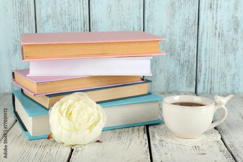 Cup of tea with books on wooden background StockFoto Adobe Stock
