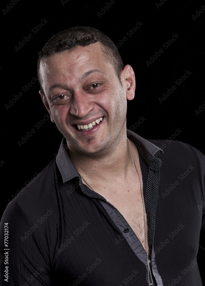 Fototapeta premium Laughing man portrait on black