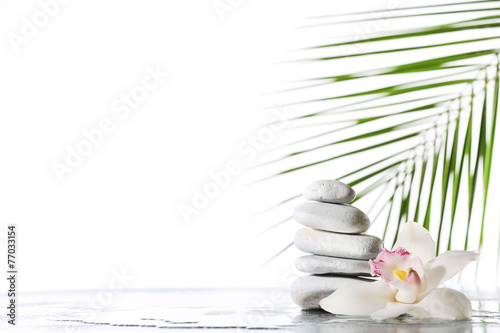 Fototapeta Naklejka Na Ścianę i Meble -  Still life of spa stones on wet glossy surface isolated on