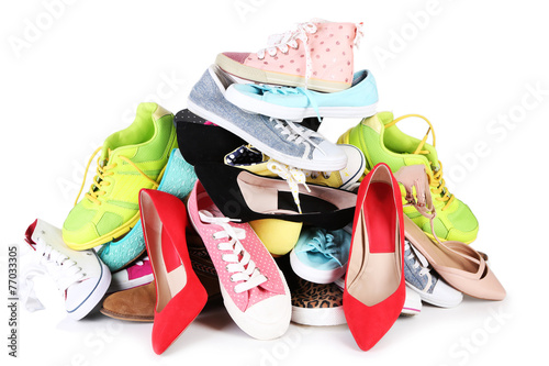 Pile of various female shoes isolated on white