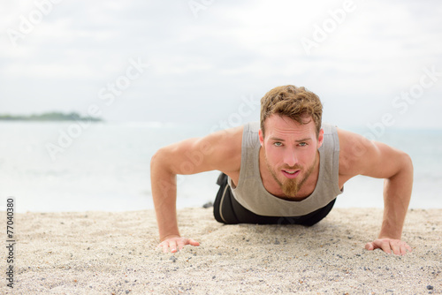 Push-up crossfit man fitness training on beach