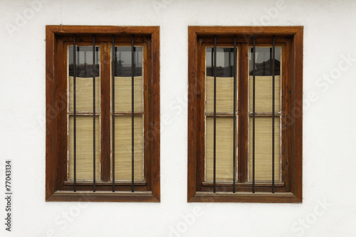 Two bulgarian old windows on white wall