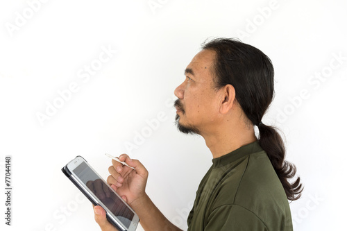 Old asian man using tablet-pc on white background.