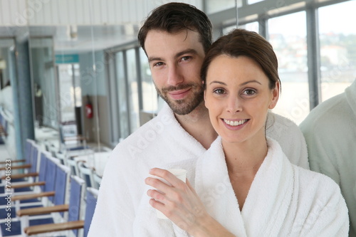 Portrait of couple in bathrobe spa center relaxation room