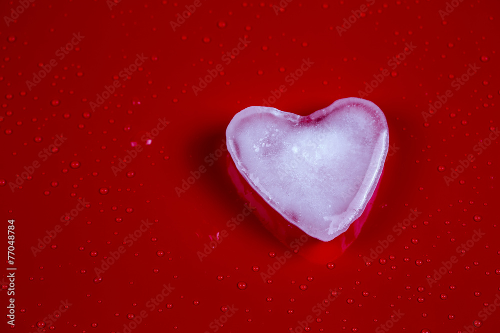 Valentines greeting card with ice heart on red background