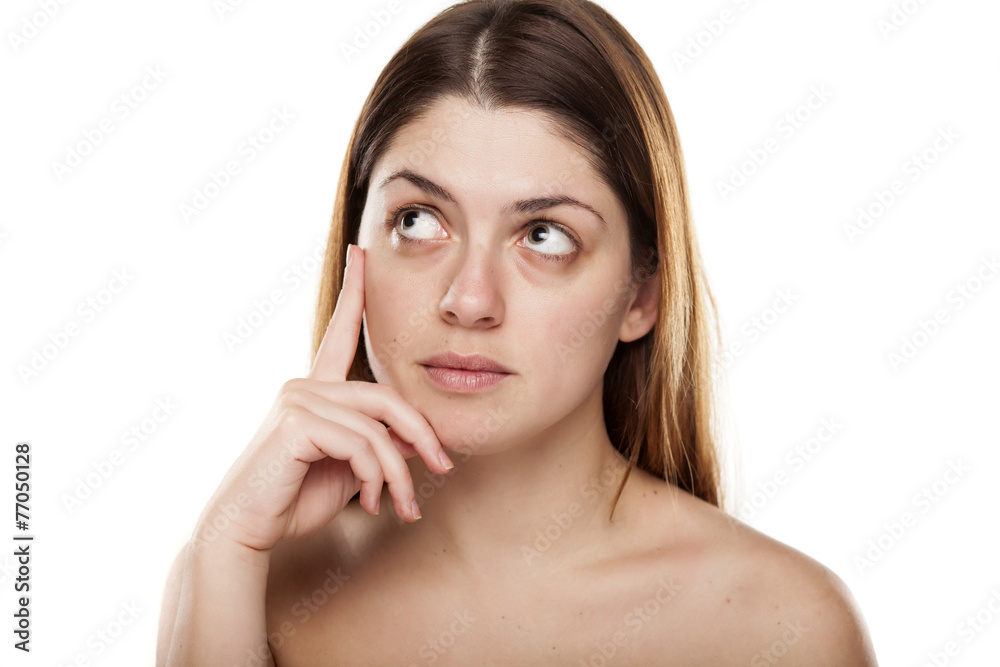 Pensive young woman without make up on white background Pensive young woman without make up on white background