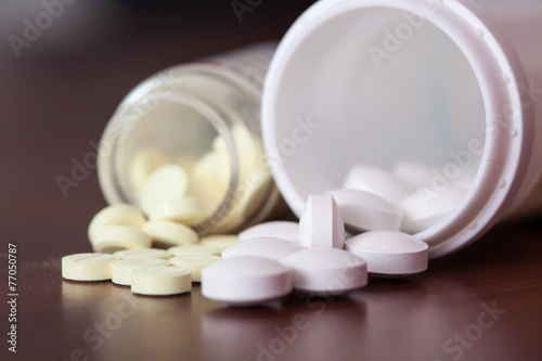 White pills redischarge on a wooden table