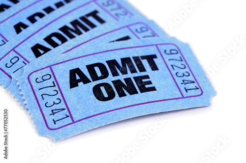 Several blue admit one movie admission tickets isolated white background photo