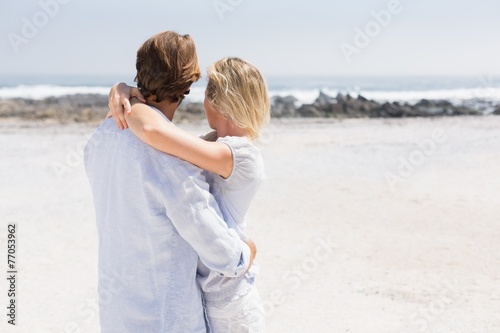 Cute couple hugging on the beach
