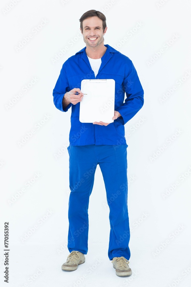 Confident mechanic showing blank clipboard Confident mechanic showing blank clipboard