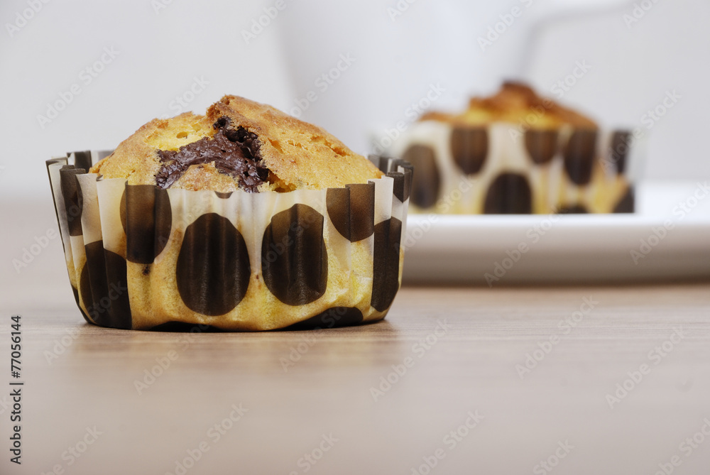 Homemade cupcakes with chocolate on a wooden table