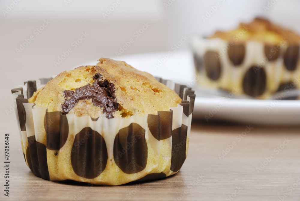Homemade cupcakes with chocolate on a wooden table