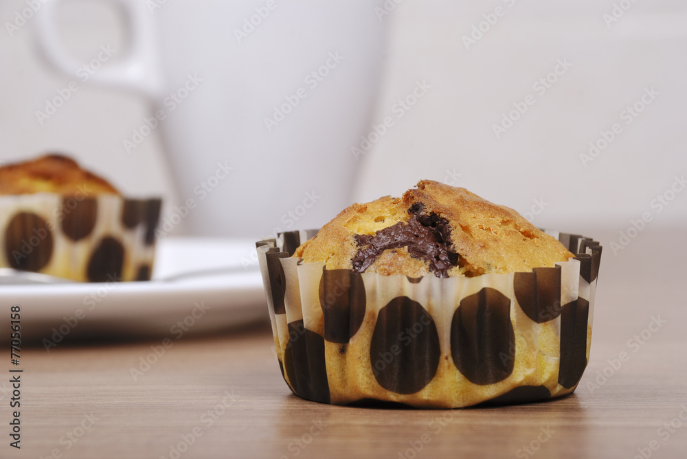 Homemade cupcakes with chocolate on a wooden table