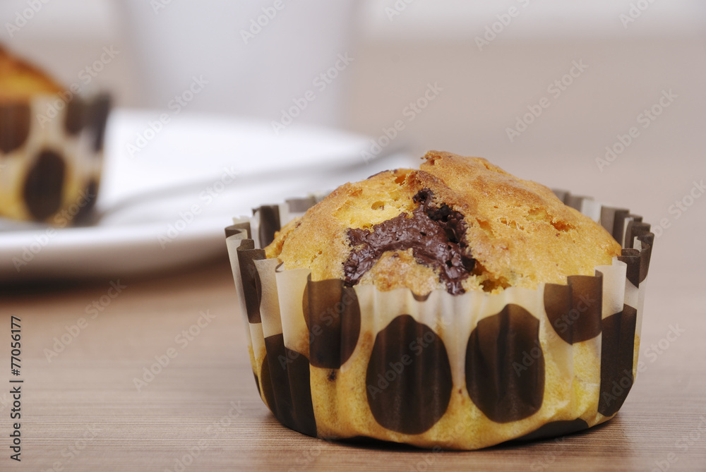 Homemade cupcakes with chocolate on a wooden table