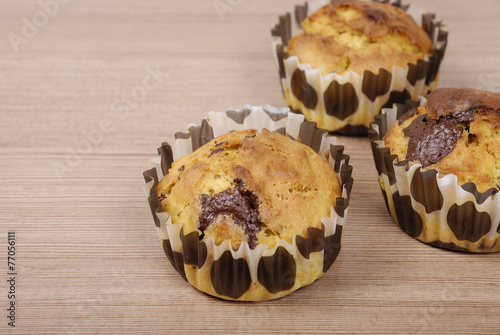 Homemade cupcakes with chocolate on a wooden table