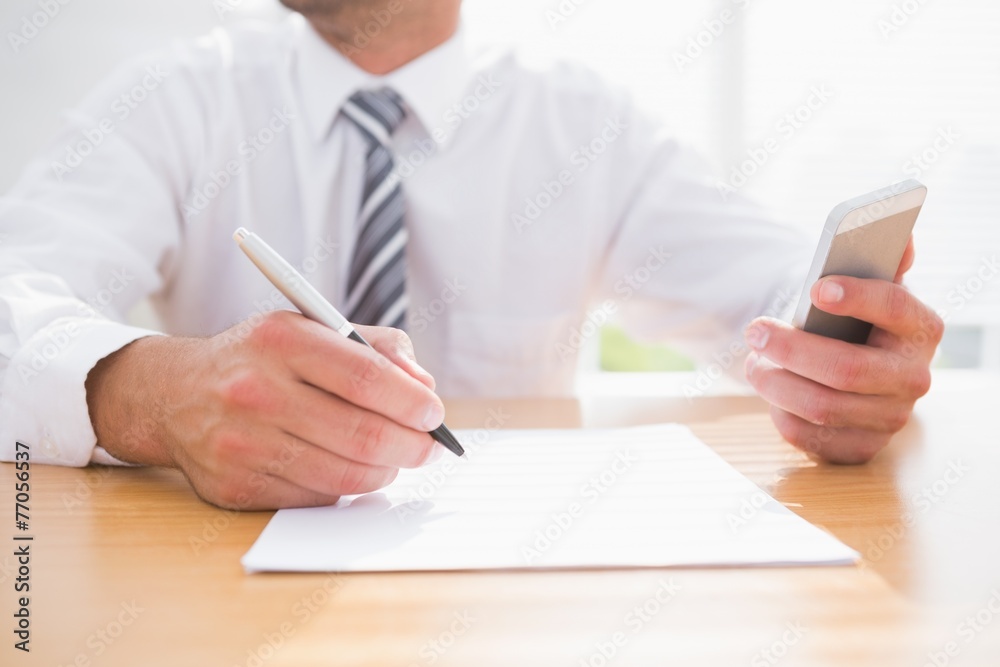 Businessman writing on a paper Businessman writing on a paper