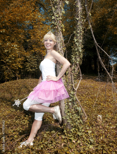 Woman leaned onto a tree