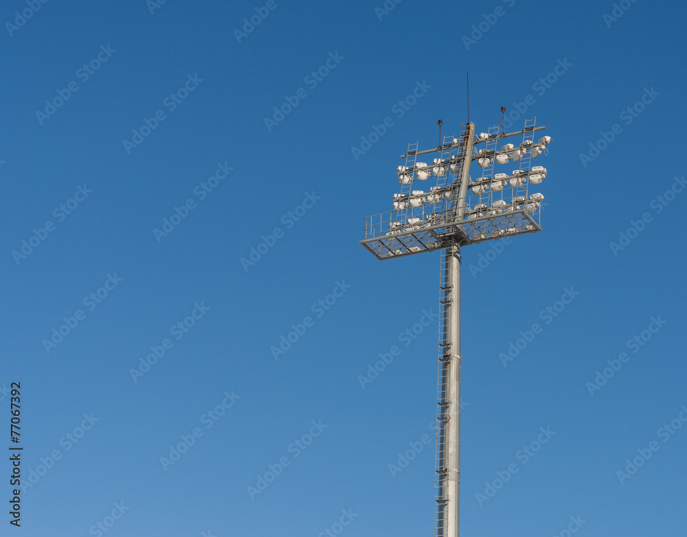 The Stadium spot-light tower over blue sky background. The Stadium spot-light tower over blue sky background.