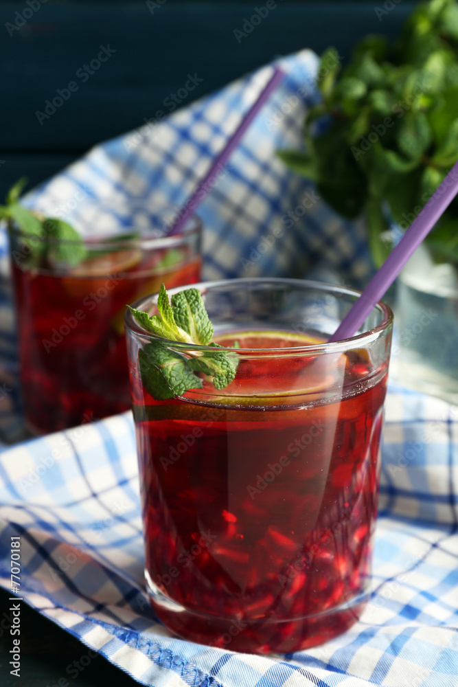 Pomegranate drink in glasses with mint and slices of lime Pomegranate drink in glasses with mint and slices of lime
