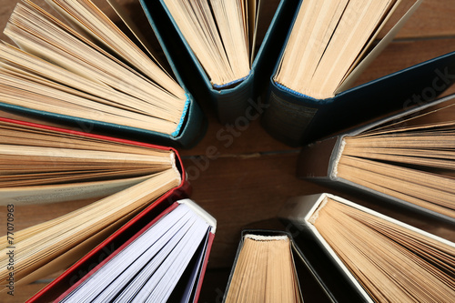 Group of books on wooden planks background, top view