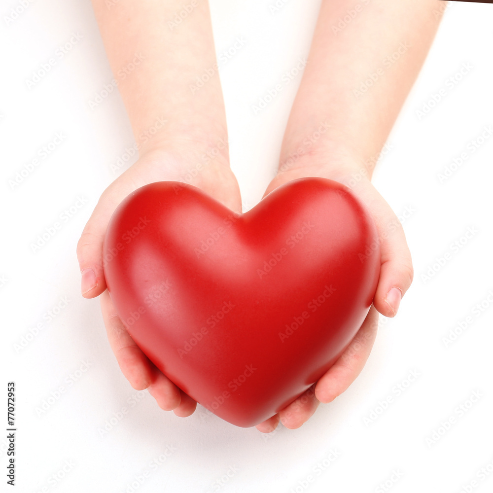 Fototapeta premium Heart in child hands isolated on white
