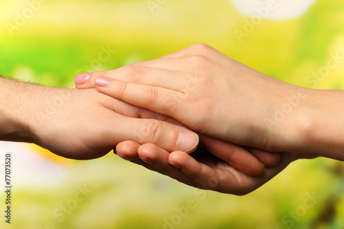 Male and female hands on bright background © Africa Studio